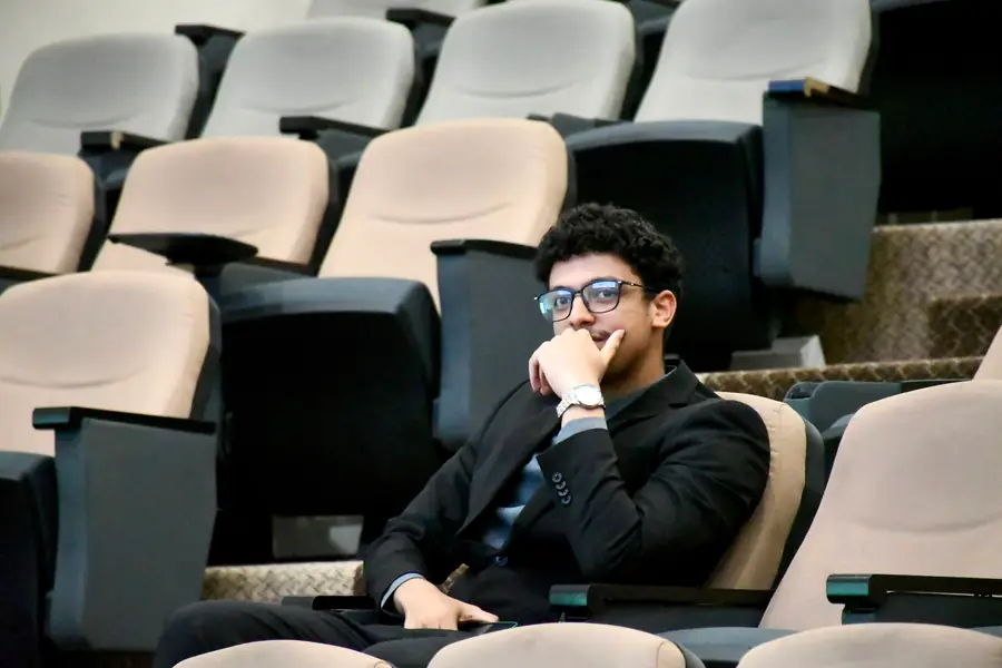 Seated in an empty lecture theatre between sessions.