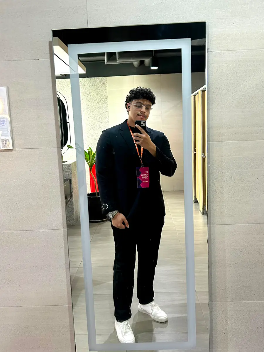A portrait taken at a conference, lanyard on.